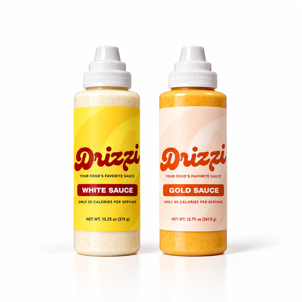 Two Drizzy sauce bottles on a white background, one labeled White Sauce with a yellow label and the other labeled Gold Sauce with a pale peach label.