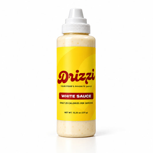 A bottle of Drizzi White Sauce with a bright yellow label, red brand logo, and white squeeze cap, shown on a clean white background.